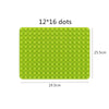 A green silicone mat with 12 by 16 dots for building marble run blocks