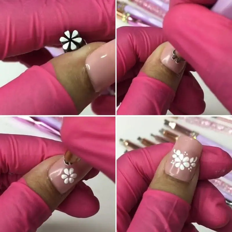 Nærbilde av en hånd som påfører blomster- og sommerfuglnagelkunst på en rosa negl.