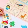 A hand draws on a set of wooden drawing stencils for kids, featuring animals and shapes.