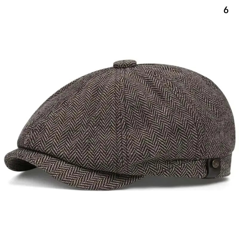 A dark gray tweed newsboy cap with a rounded crown and a folded brim shown from above.