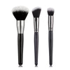 A set of three professional makeup brushes with silver ferrules and black bristles for foundation, concealer, and blush appli