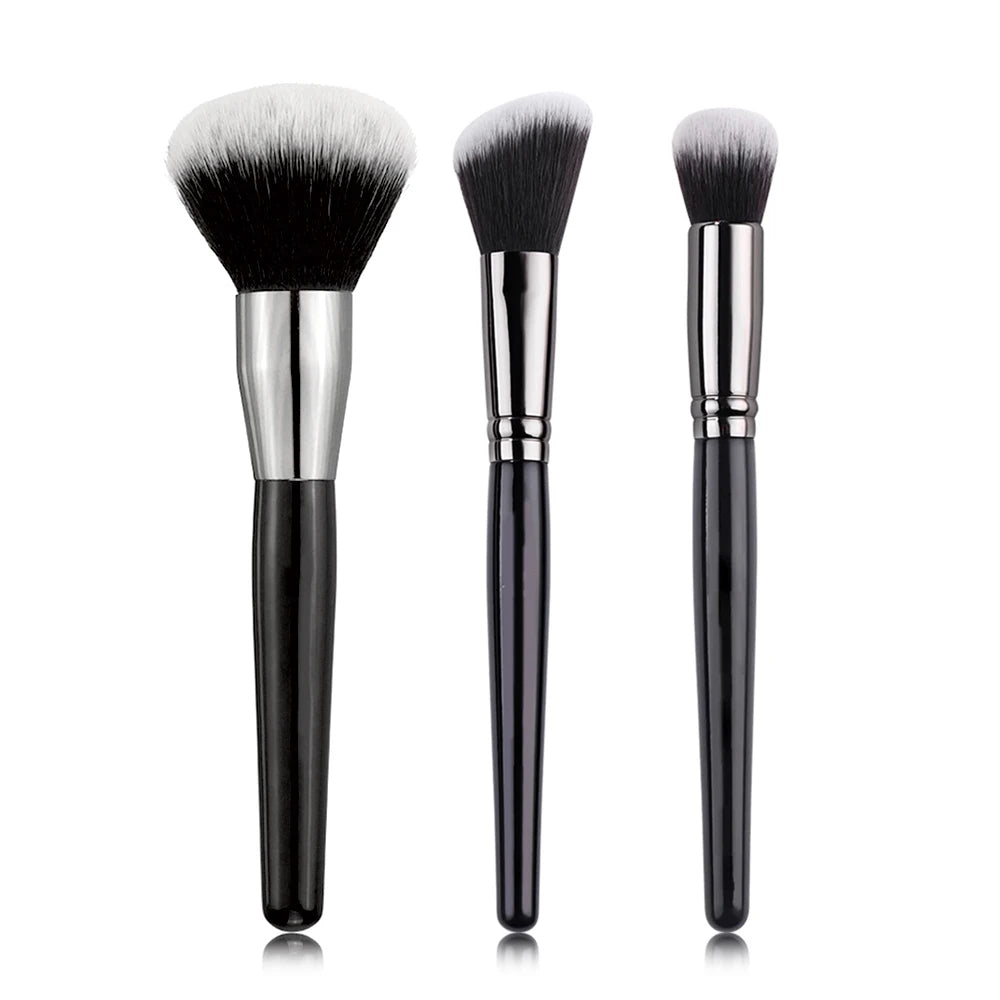 A set of three professional makeup brushes with silver ferrules and black bristles for foundation, concealer, and blush appli