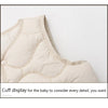 A close-up view of a beige quilted vest cuff display for a baby.