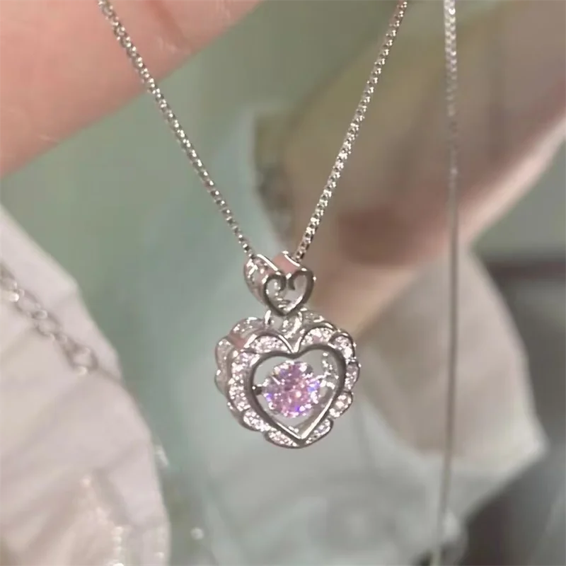 Silver heart pendant necklace featuring a purple gemstone surrounded by small diamonds and angel wings.