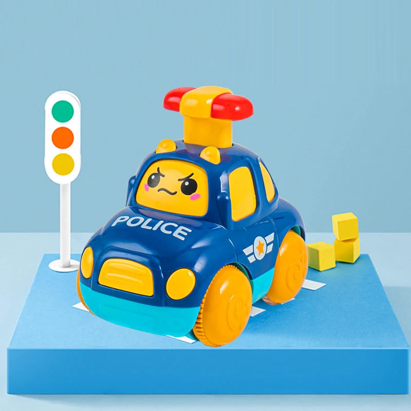 A blue and yellow police car toy with lights is displayed on a blue platform next to a traffic light.