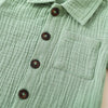 A light sage green linen shirt with a collar and buttons, shown flat lay.
