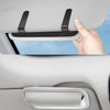 A hand is shown placing a PU leather car visor sunglasses case with a hook-and-loop strap onto a vehicle window.