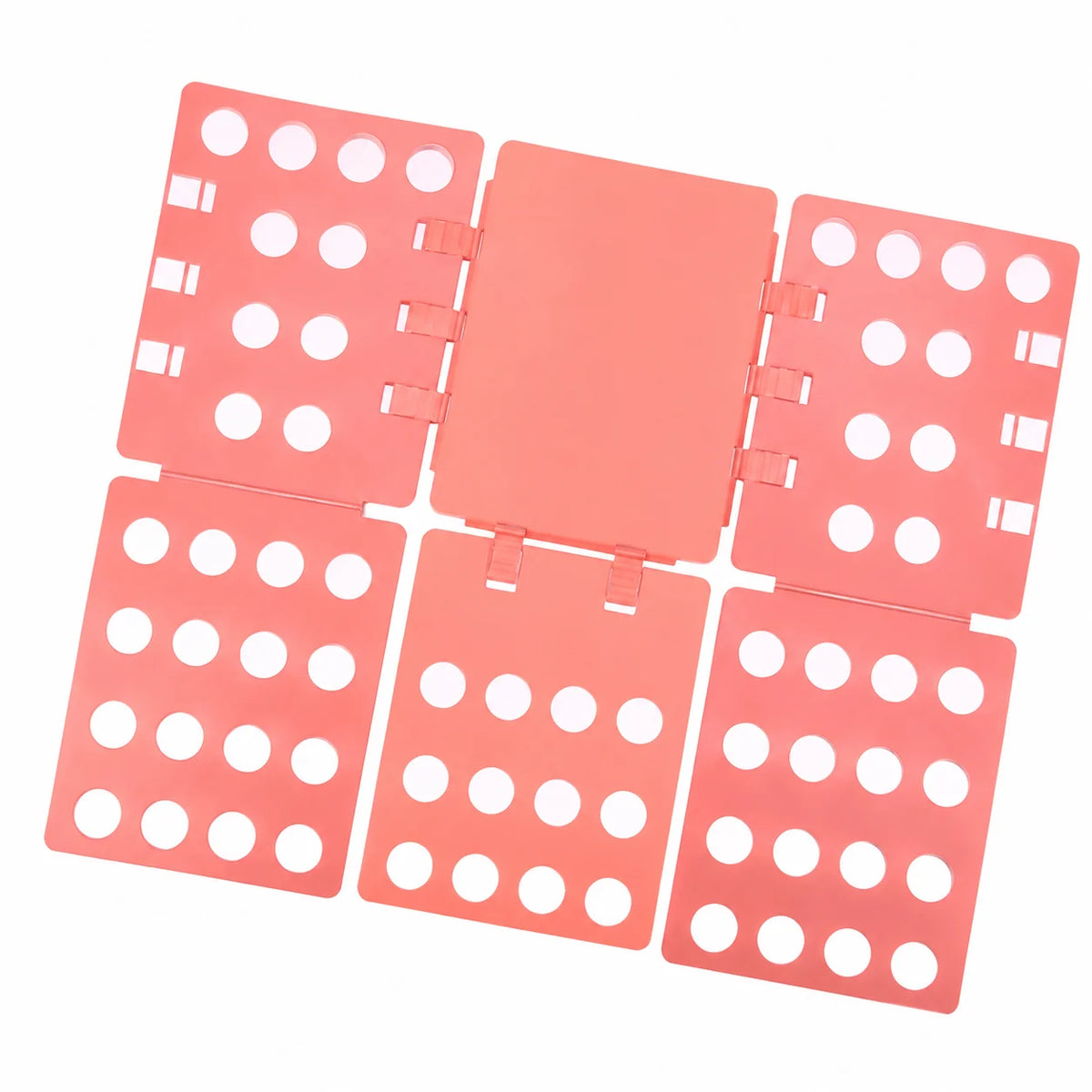 A pink clothes folding board with multiple compartments and circular holes for organizing laundry.