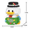 A white and black micro building block figurine of a bird with green and yellow accents.
