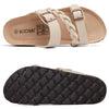 A tan women's slide sandal with a cork footbed and beige strap, shown from the side and bottom.