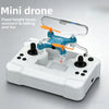 A small blue mini drone with orange propellers is shown resting on a white control base.
