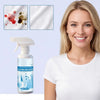 A woman holds a bottle of clothing emulsifier spray for removing stains.