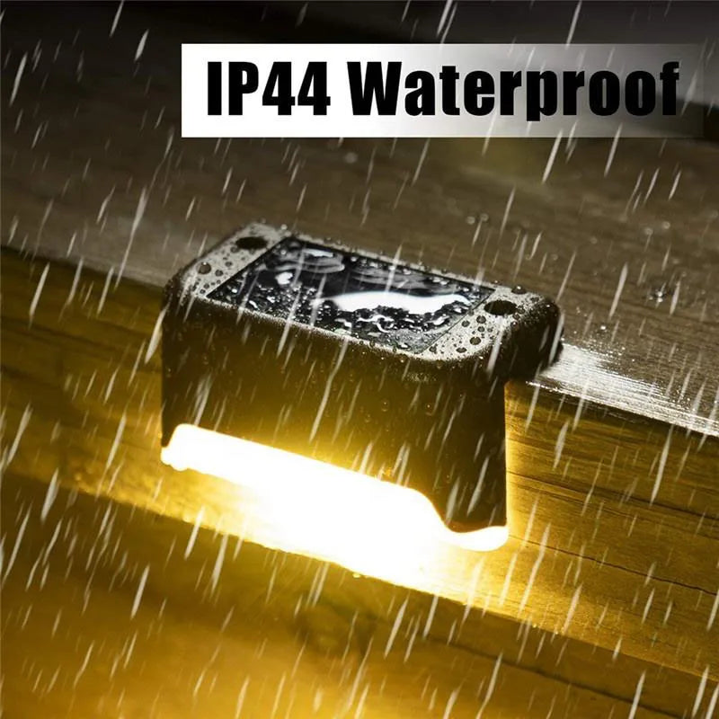 A solar powered deck light illuminates a wooden surface, demonstrating IP44 waterproof protection.
