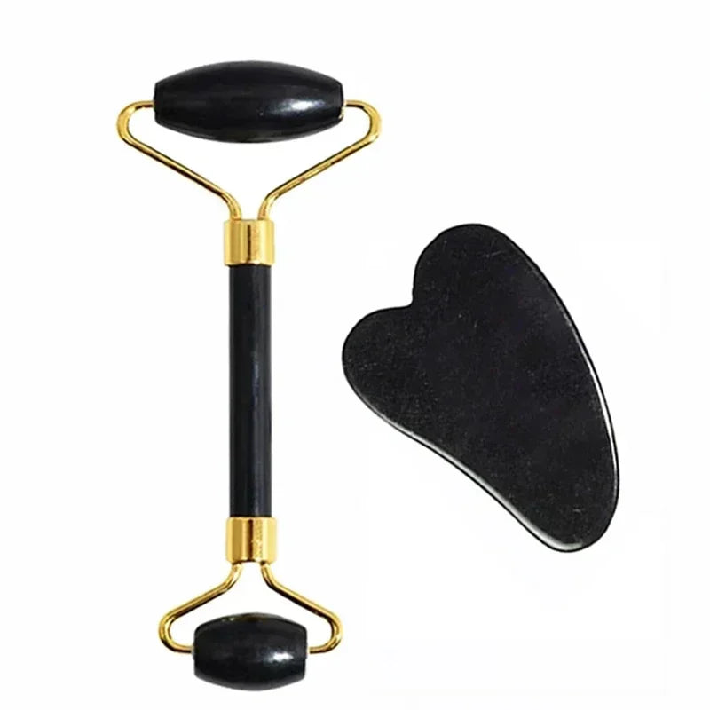 Set de rodillo de jade y gua sha tono dorado con piedra negra, sobre fondo blanco.