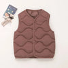 A mauve quilted vest for a child, displayed next to a small stuffed animal.
