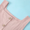 A pink sleeveless cotton dress for a toddler girl shown in a close-up view.