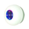 A white, round waterproof Bluetooth speaker with a suction cup mount visible against a white background.