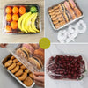 A collection of reusable elastic food covers and lids for bowls and produce, including various fruit and food items.