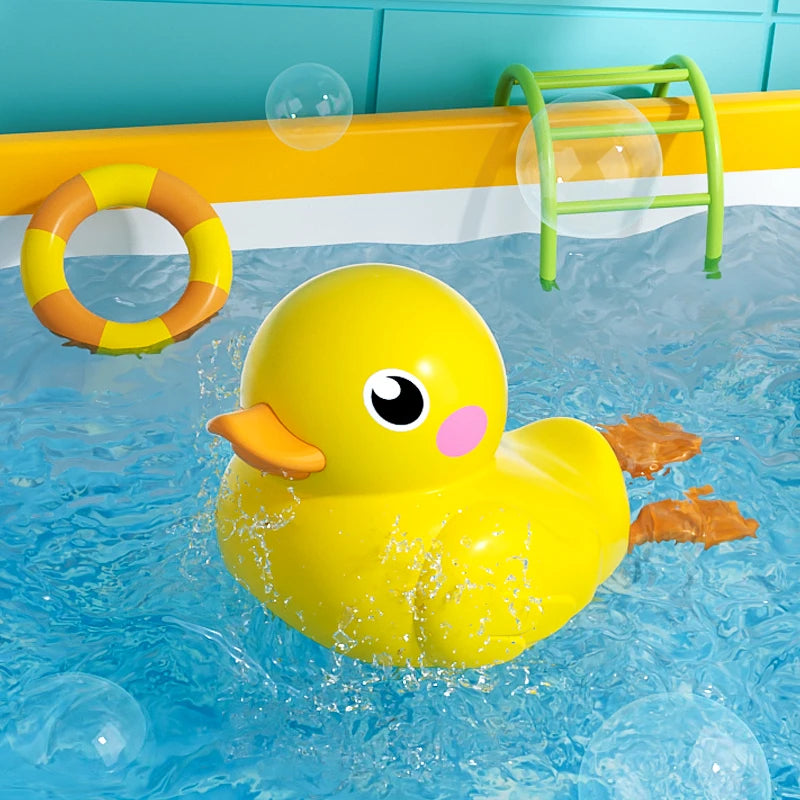 A yellow rubber duck floating in blue water with a green plastic toy nearby.