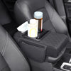 A car center console organizer with an armrest cushion and cup holder placed on a black leather car seat.