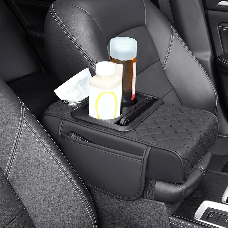 A car center console organizer with an armrest cushion and cup holder placed on a black leather car seat.