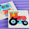 A wooden jigsaw puzzle featuring colorful 3D animals, including an owl and a train, set against a purple background.
