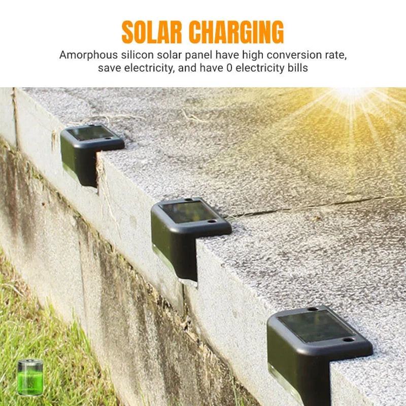 Four solar powered deck lights are mounted on a concrete retaining wall for outdoor pathway illumination.