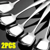 Two stainless steel serving spoons with long handles shown against a dark background.