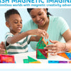 A mother and son are building structures with colorful magnetic tiles on a table.
