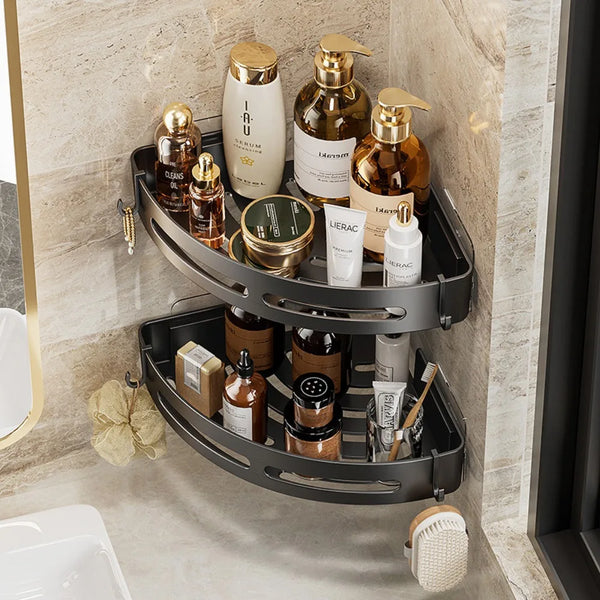 A black adhesive shower caddy with multiple compartments holds various glass and cream bottles for bathroom storage.