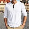 A man wearing a white long-sleeve casual shirt with a collar and chest pocket, standing outdoors.