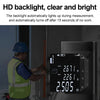 A person measures a distance using a handheld laser distance measurer with a bright backlit display.