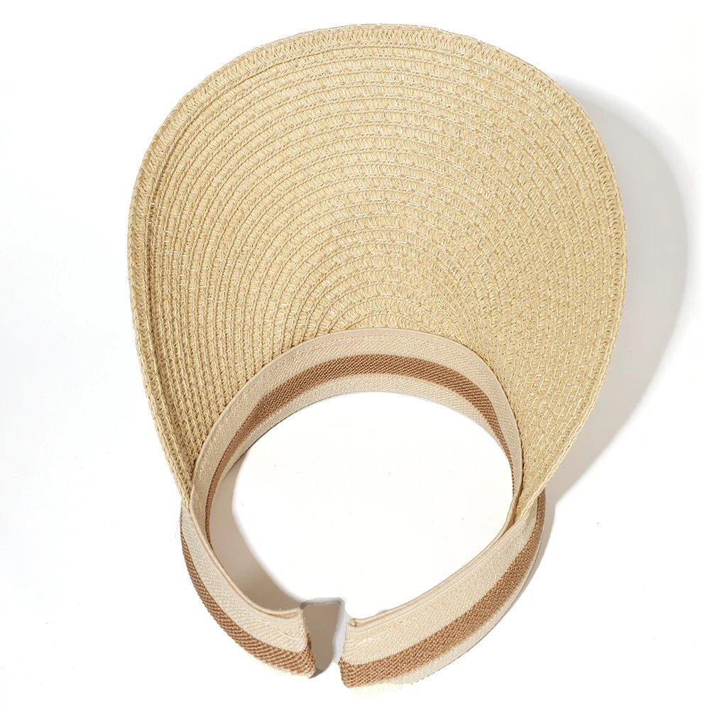 A woven straw sun hat with a wide brim and a beige color shown against a white background.