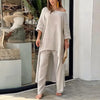 Kvinne modellerer et to-delt loungesett i bomull-lin, med off-shoulder topp og vide bukser.