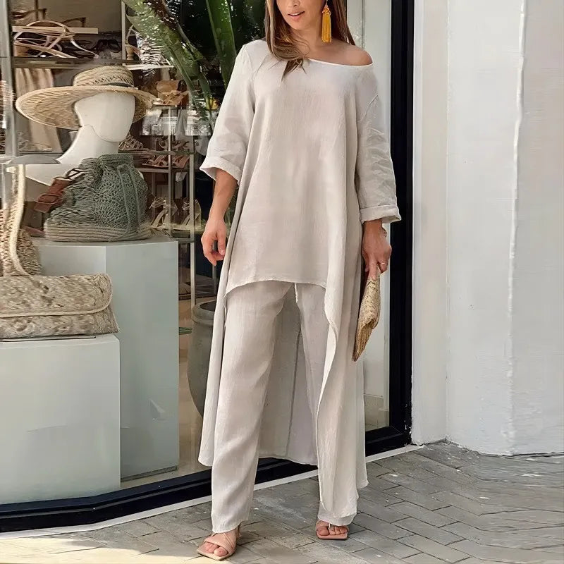Kvinne modellerer et to-delt loungesett i bomull-lin, med off-shoulder topp og vide bukser.