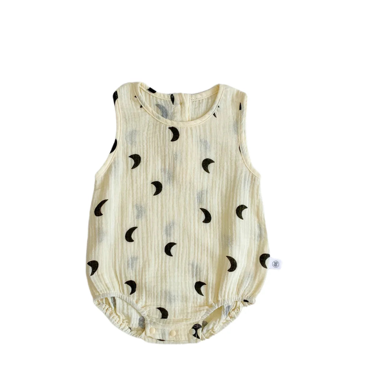 A cream-colored baby cotton sleeveless jumpsuit bodysuit set with small black crescent moon patterns.