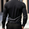 A man wearing a black long-sleeve formal shirt and dark pants, viewed from the back.