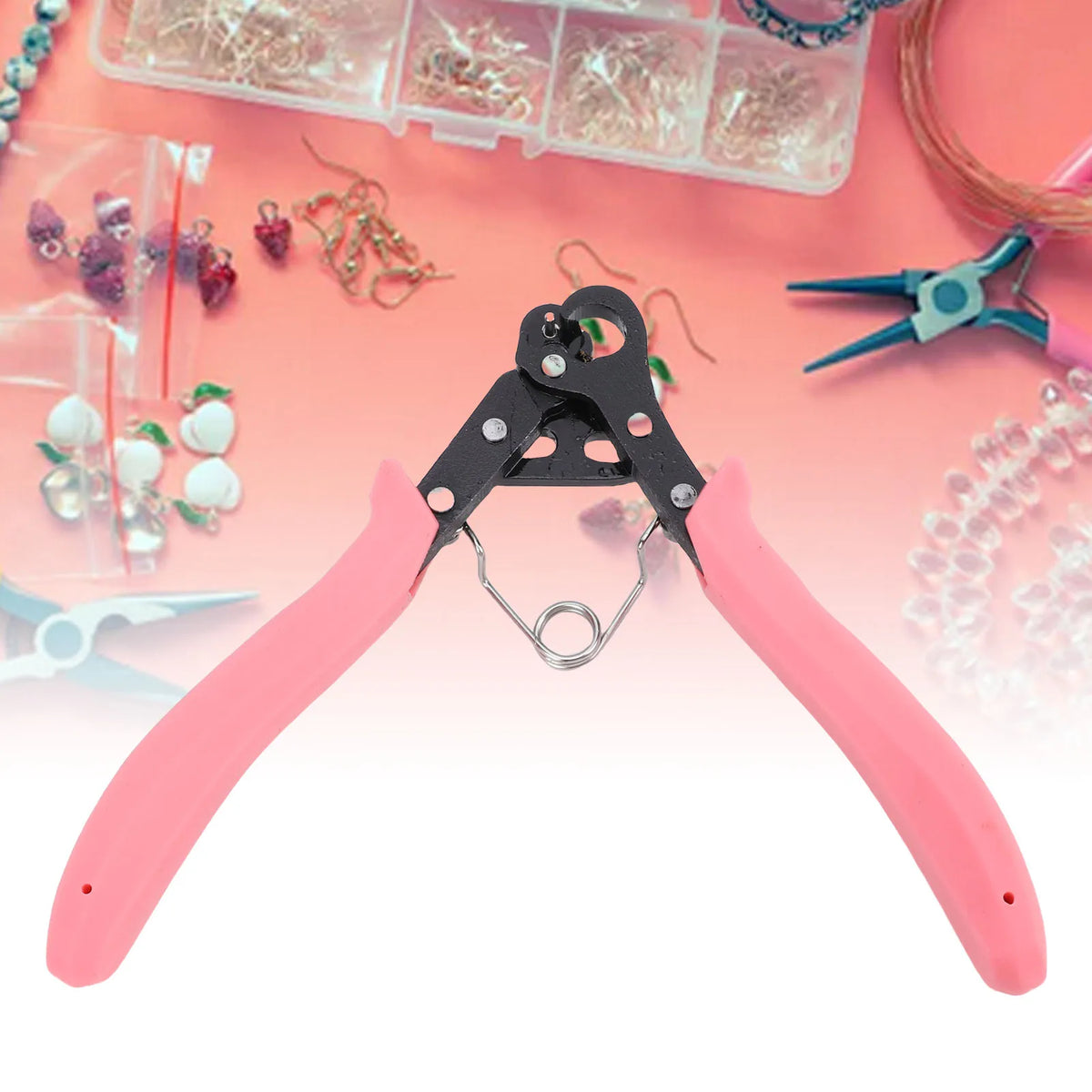 Pink one-step wire looping pliers used for jewelry making with various wires and beads.