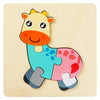 A wooden jigsaw puzzle shaped like a yellow and pink cartoon calf.