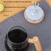 A clear mug with a wooden handle is shown next to a white stirring rod and a circular base for a three-pronged stirring rod.