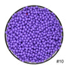 A circular arrangement of purple water beads in a black dish.