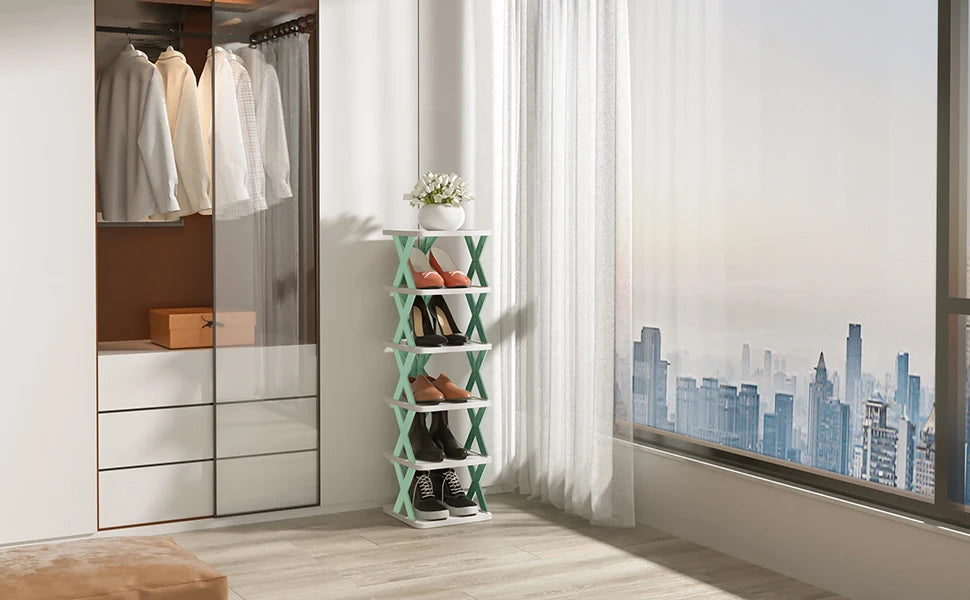 A vertical modular shoe rack with light green shelves holds pairs of shoes near a large window.