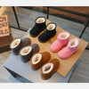 A display of kids winter ankle boots in black, pink, and brown suede with plush lining.