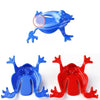 A set of three plastic frog toys in blue and red for kids party favors or stress relief