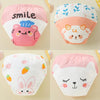 Four reusable cotton potty training pants for toddlers featuring cute animal faces and text designs.