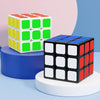 A stack of colorful 3x3 speed cubes, featuring red, yellow, and green faces, displayed on a white stand.