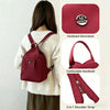 A maroon mini backpack with a leather hardware decoration and shoulder strap shown on a woman's chest.