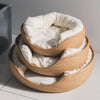 A stack of handwoven bamboo pet beds with removable white cushions.