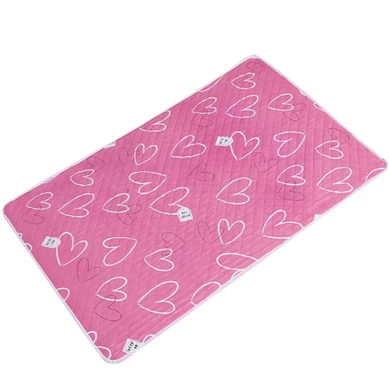 Pink waterproof baby mattress protector featuring a cute heart cartoon design.