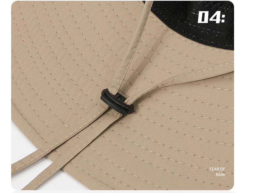 A close-up view of a beige mesh bucket hat with black adjustable strap and a black patch displaying 04: and Fear of Rain.